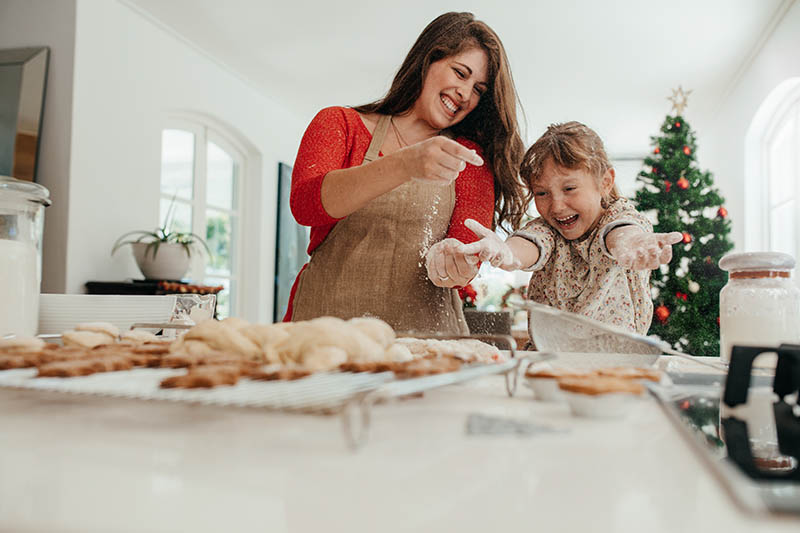 Mother and daughter having fun while making Christmas cookies.